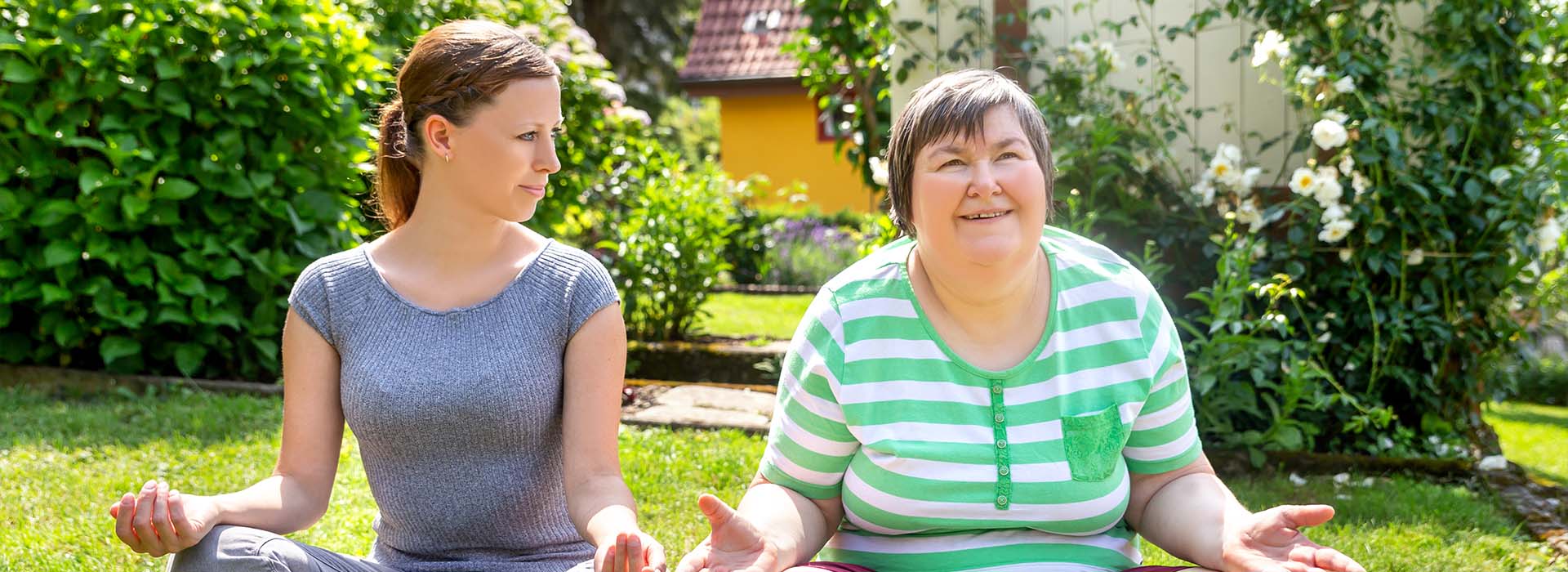 A client relaxing in the sun with a caregiver from Total Home Care LLC